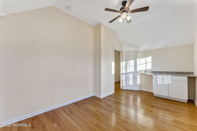 unfurnished living room featuring ceiling fan, vaulted ceiling, and light hardwood / wood-style flooring