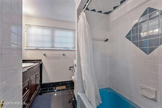 full bathroom with vanity, tile patterned floors, toilet, shower / bathtub combination with curtain, and tile walls