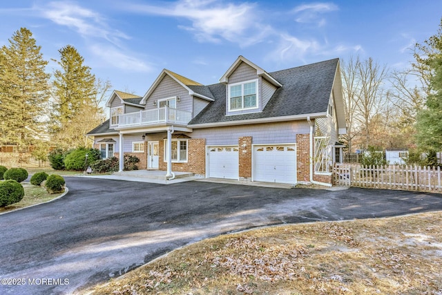 view of front of home with a balcony and a garage