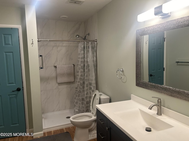 bathroom with vanity, hardwood / wood-style flooring, toilet, and curtained shower