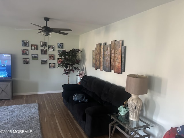 living room with dark hardwood / wood-style floors and ceiling fan