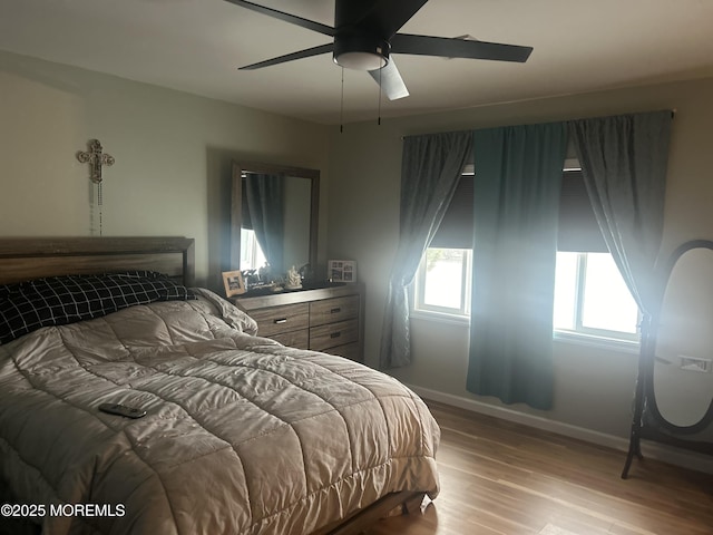 bedroom with ceiling fan and light hardwood / wood-style floors