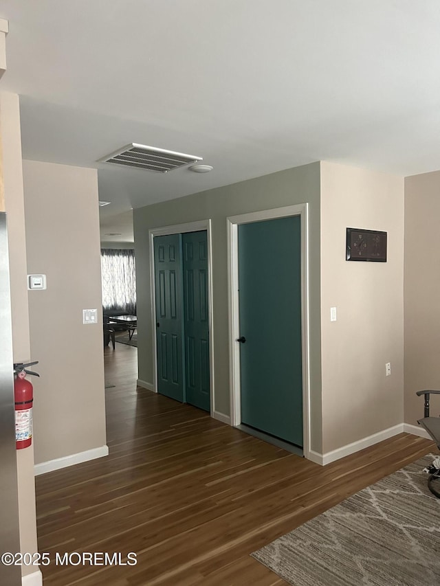 hall with dark hardwood / wood-style floors