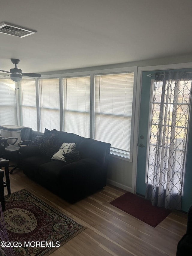 living room with hardwood / wood-style floors and ceiling fan