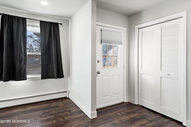 foyer with dark hardwood / wood-style floors and a baseboard heating unit