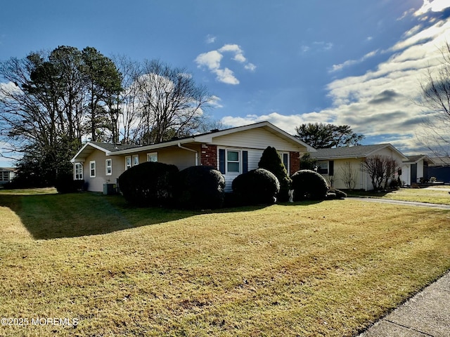 view of front of house with cooling unit and a front lawn