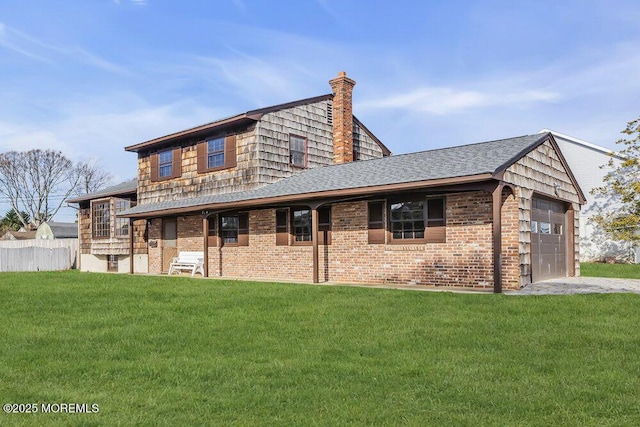 back of house with a yard and a garage