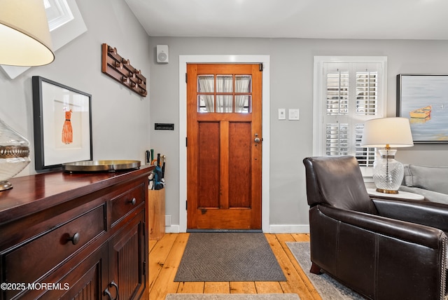 entrance foyer with light wood-style flooring and baseboards