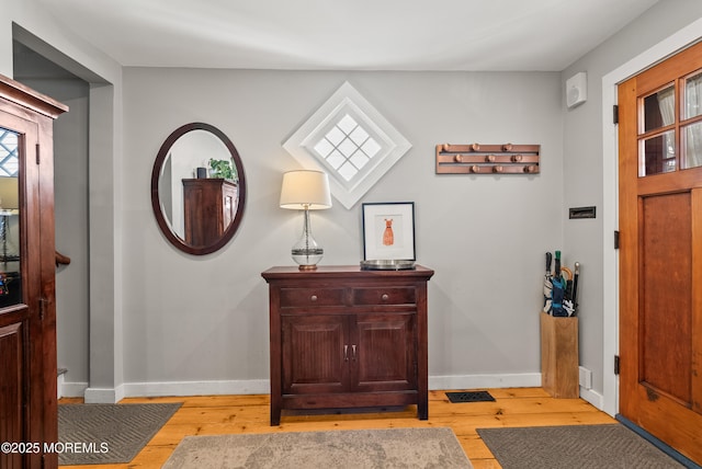 entrance foyer with light wood-type flooring and baseboards