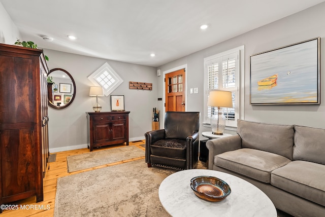 living area with recessed lighting, light wood-style flooring, and baseboards