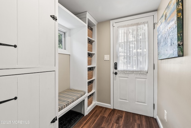 mudroom with dark wood-style flooring and baseboards