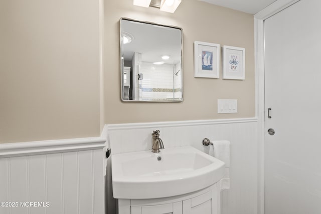 bathroom featuring a wainscoted wall and vanity