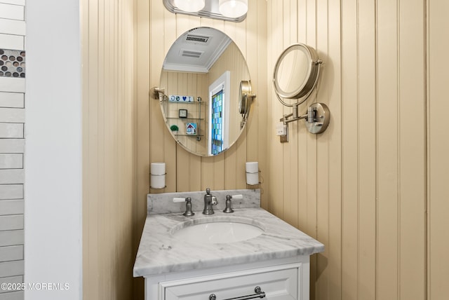 bathroom with wood walls and vanity