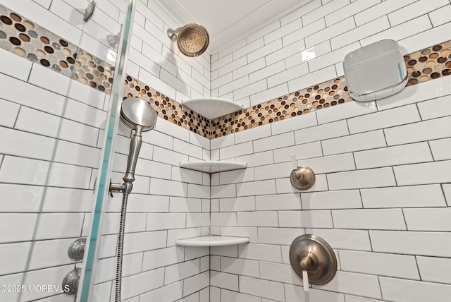 full bath with a tile shower