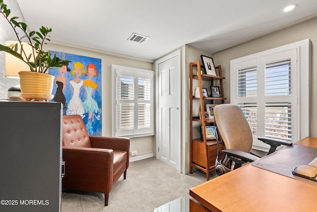 carpeted office featuring visible vents and baseboards