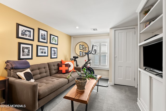 carpeted living area with baseboards and visible vents