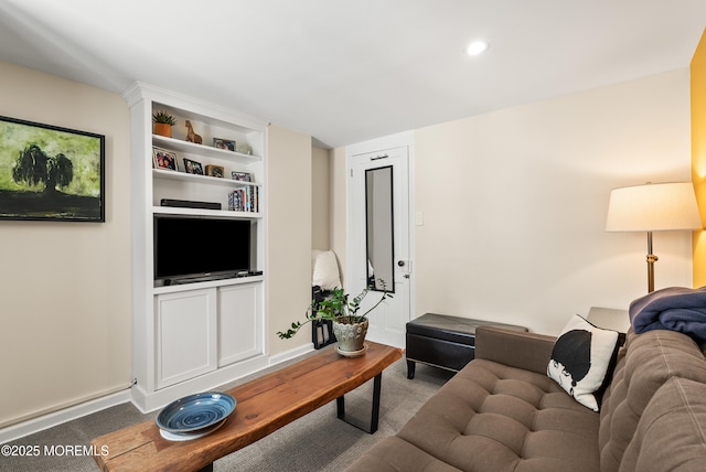 living room with built in shelves, recessed lighting, baseboards, and wood finished floors