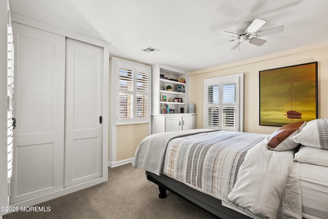 carpeted bedroom featuring a closet, visible vents, and baseboards