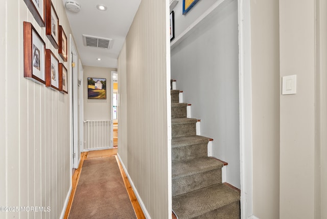 interior space featuring visible vents, baseboards, light colored carpet, stairway, and recessed lighting