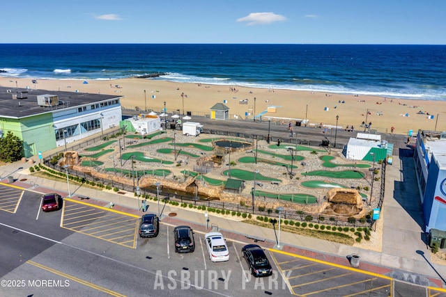 birds eye view of property with a water view and a view of the beach