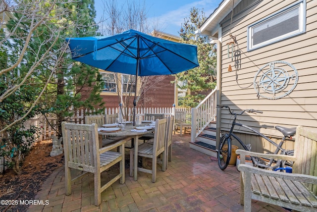 view of patio with fence and outdoor dining area