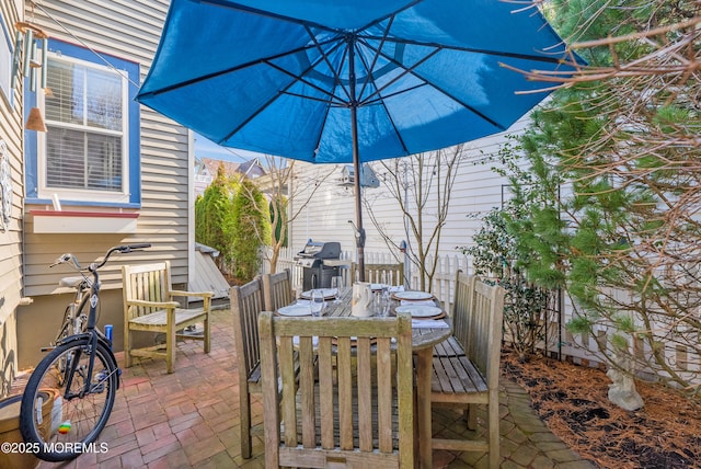 view of patio / terrace featuring outdoor dining space, fence, and grilling area