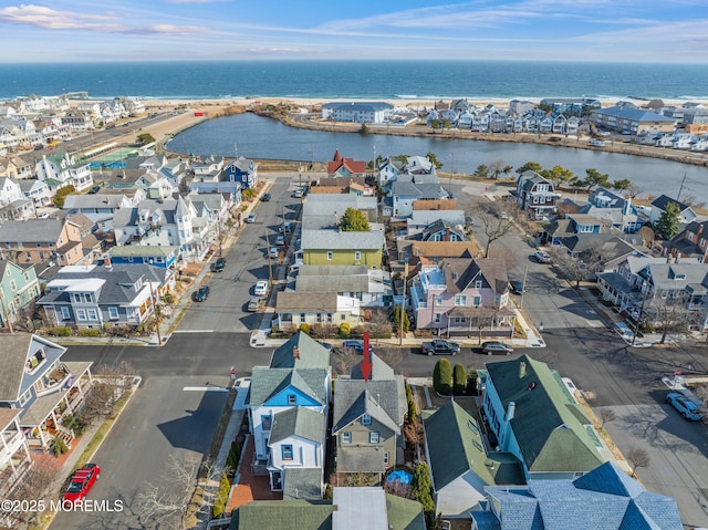 drone / aerial view featuring a residential view and a water view