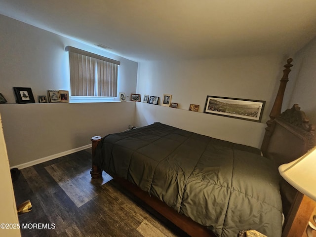 bedroom with dark wood-type flooring