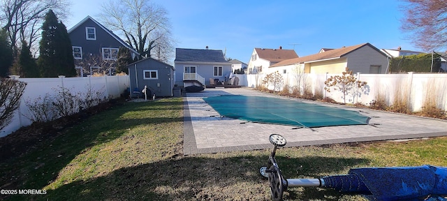 view of swimming pool featuring a lawn and a patio area