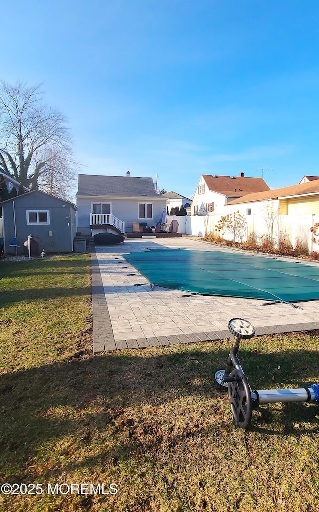 view of swimming pool featuring a yard, a patio, and a wooden deck