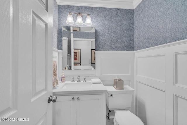 bathroom with crown molding, vanity, and toilet