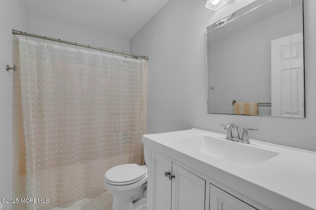 bathroom featuring toilet, vanity, and walk in shower