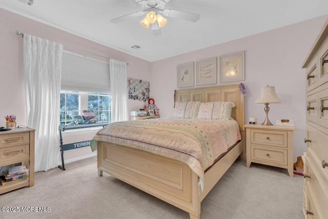 bedroom featuring light carpet and ceiling fan