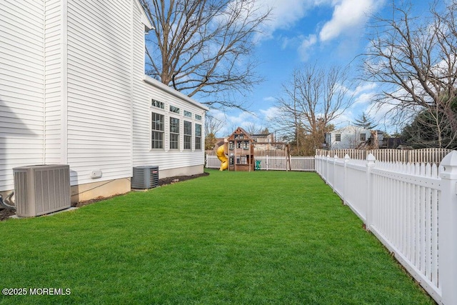 view of yard featuring a playground and central air condition unit