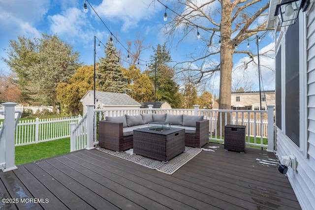 wooden deck with central air condition unit, an outbuilding, and outdoor lounge area