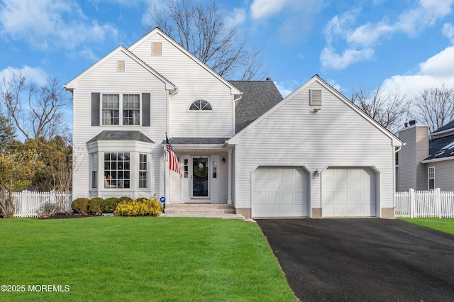 view of property featuring a front yard and a garage