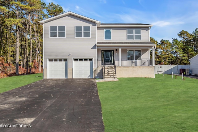 view of front of house with a porch, a front yard, and a garage