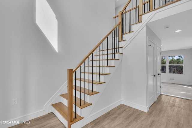 stairs featuring hardwood / wood-style flooring