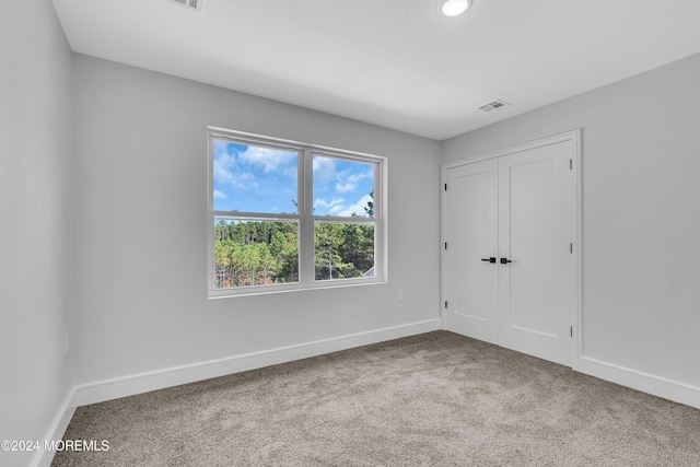 spare room with light colored carpet