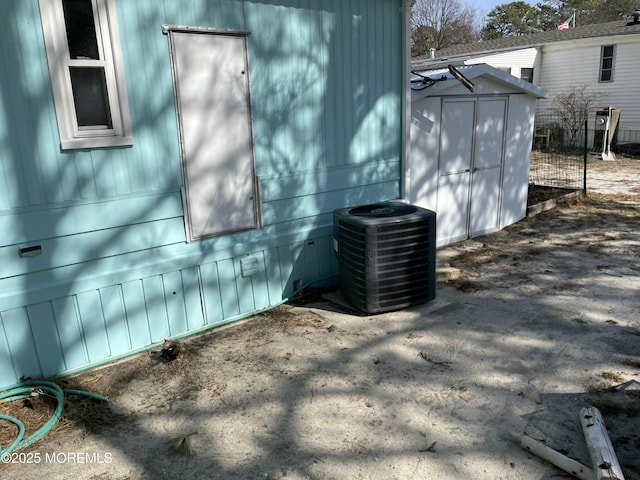 view of side of property featuring a storage unit, crawl space, an outdoor structure, and central air condition unit