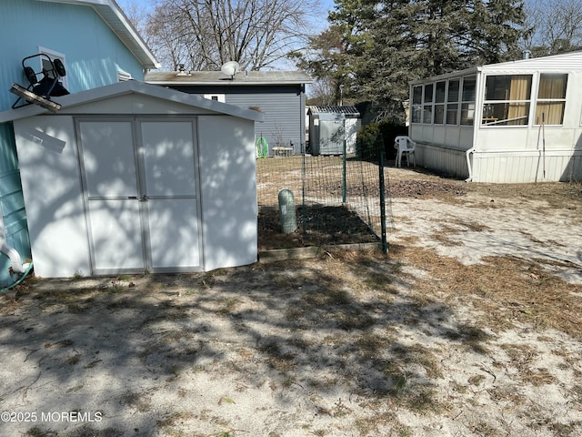 view of yard featuring an outbuilding, fence, and a storage shed