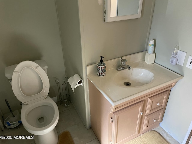 bathroom with tile patterned flooring, vanity, and toilet