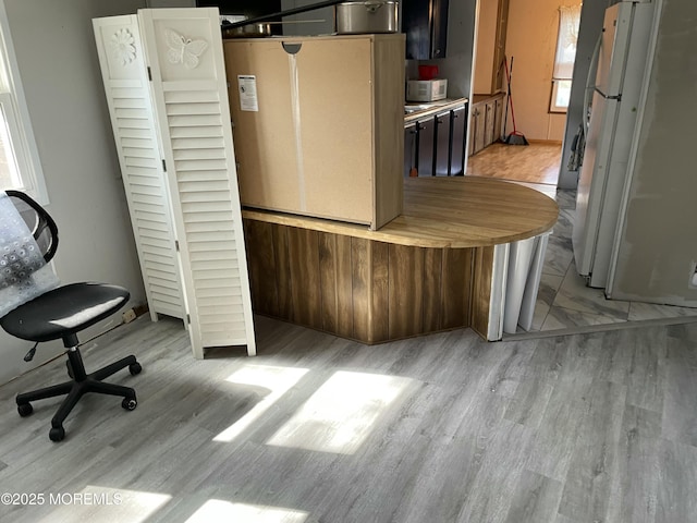 kitchen with white appliances and light wood-style flooring