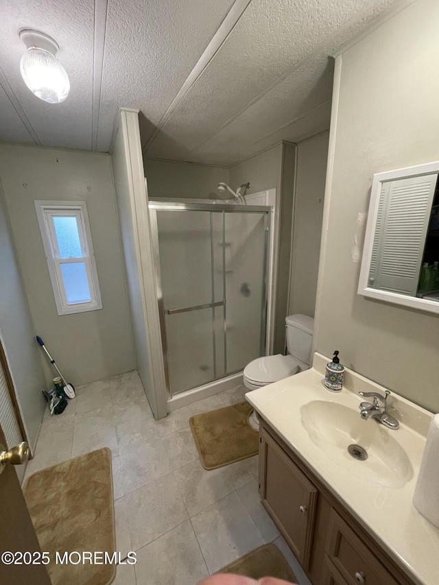 12 Pigeon Ct, Whiting, NJ 08759 - bathroom featuring a textured ceiling, a stall shower, vanity, tile patterned floors, and toilet