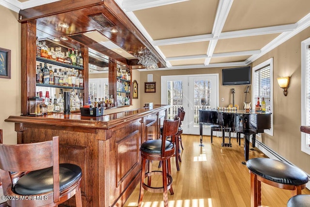 bar featuring french doors, coffered ceiling, beamed ceiling, light wood-type flooring, and ornamental molding