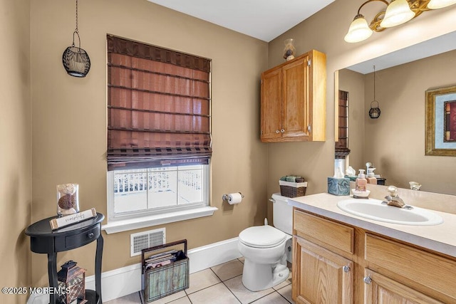 bathroom featuring tile patterned floors, vanity, and toilet