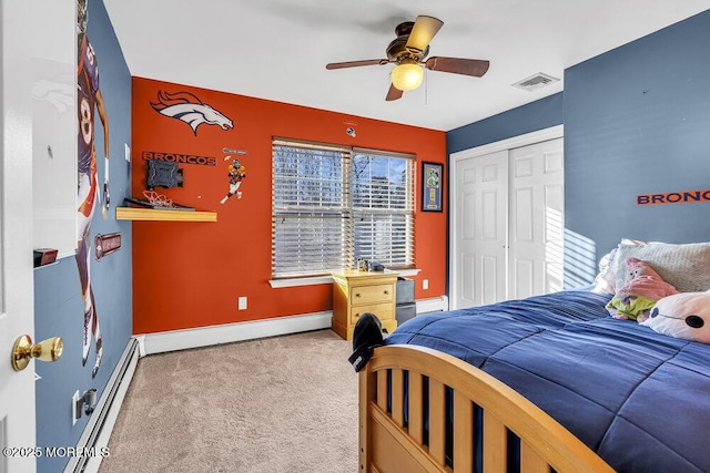 bedroom with carpet flooring, ceiling fan, a baseboard radiator, and a closet