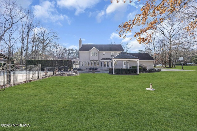 back of house featuring a lawn