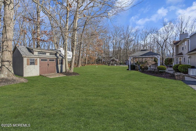 view of yard with a gazebo and a storage shed