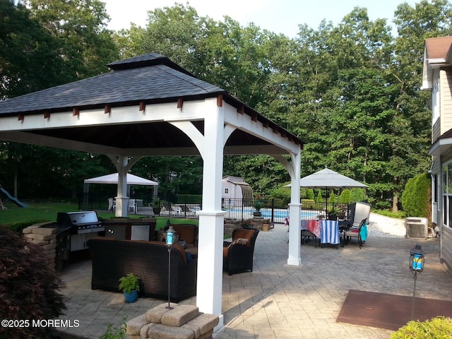 view of patio / terrace featuring a gazebo, a pool, area for grilling, and central AC unit